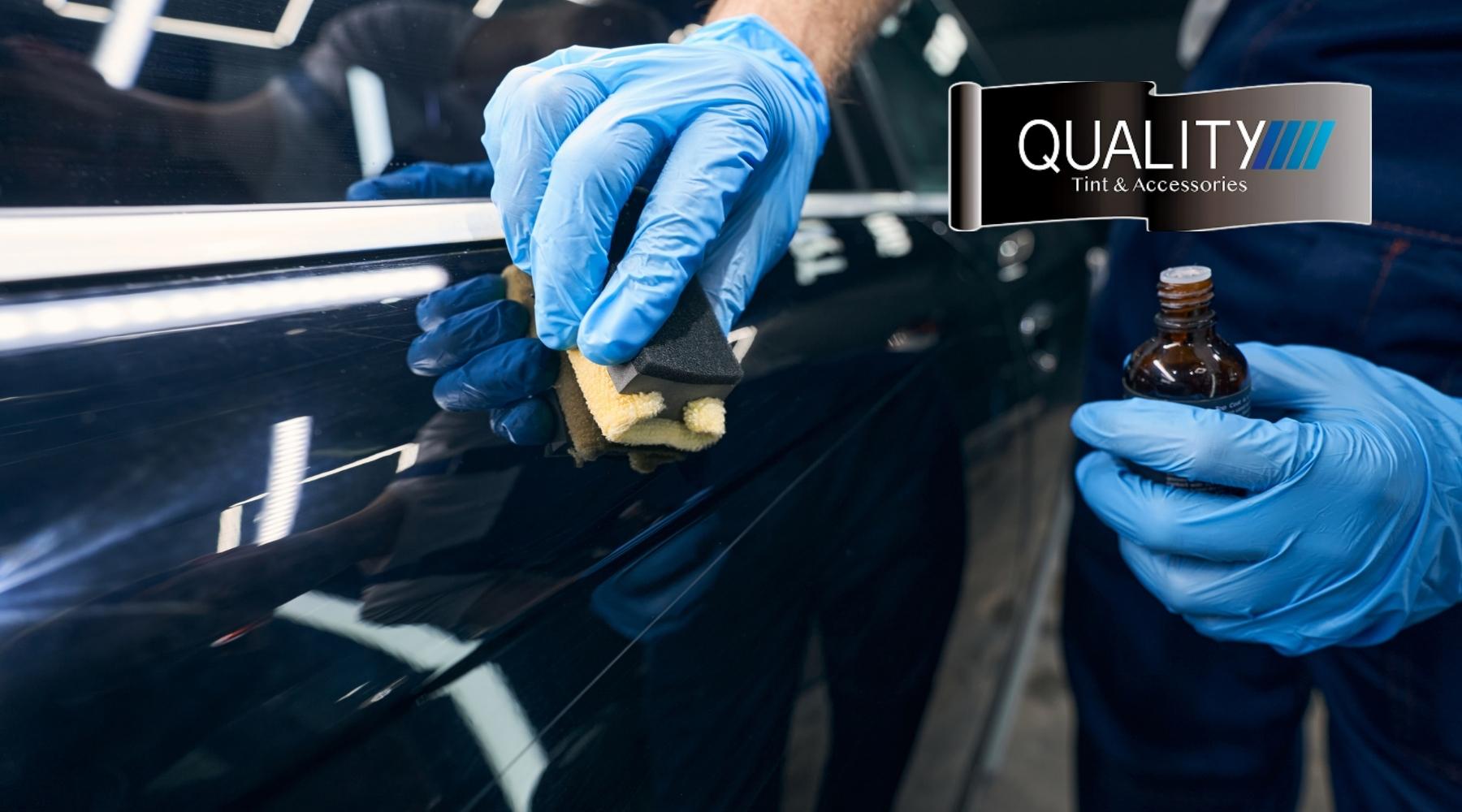 Technician applying ceramic coating to a car’s paint using a foam applicator for long-lasting protection and shine.