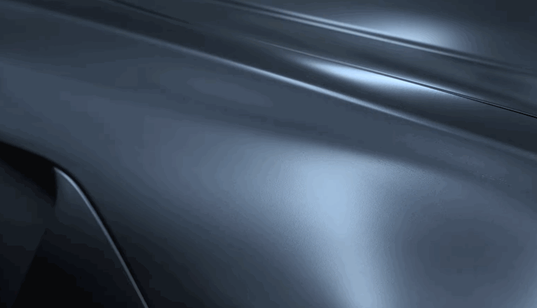 Close-up of a dark vehicle's surface with smooth, even reflections, showing the glossy effect after ceramic coating application.